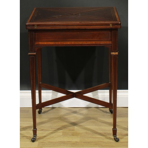 1890 - An Edwardian satinwood crossbanded mahogany envelope card table, hinged top enclosing a baize lined ... 