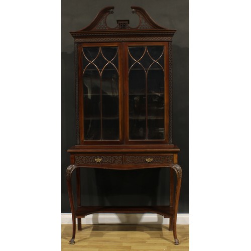 2442 - A Chippendale Revival mahogany display cabinet, fretwork swan neck pediment above a pair of glazed d... 