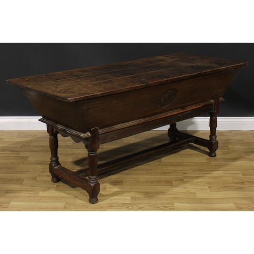 1996 - An 18th century joined oak dough bin or proving trough, three plank top, the side carved with a flor... 