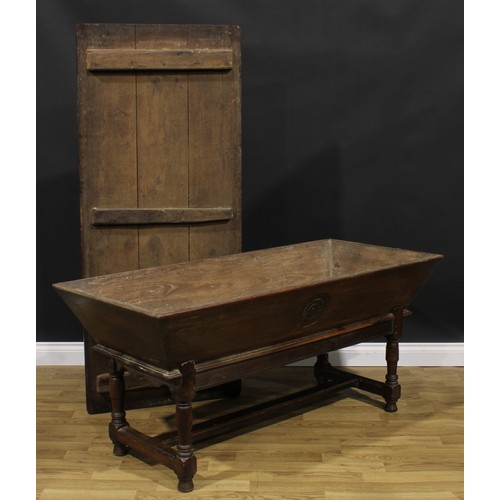 1996 - An 18th century joined oak dough bin or proving trough, three plank top, the side carved with a flor... 