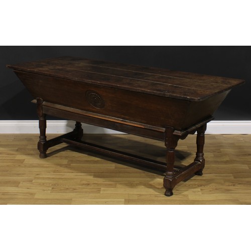 1996 - An 18th century joined oak dough bin or proving trough, three plank top, the side carved with a flor... 