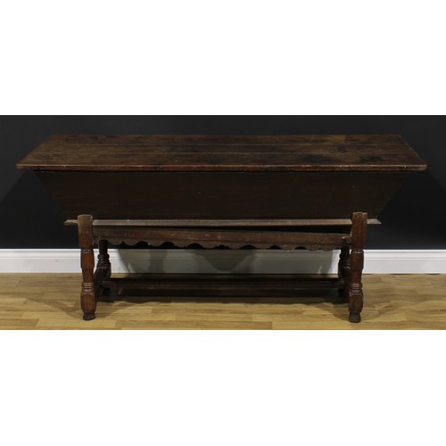 1996 - An 18th century joined oak dough bin or proving trough, three plank top, the side carved with a flor... 