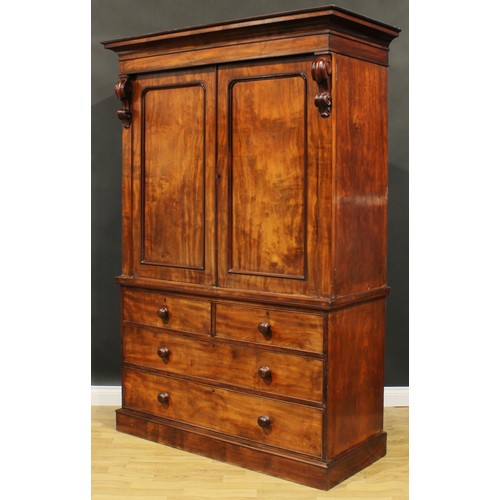 2585 - A Victorian mahogany linen press, concave moulded cornice above a pair of panel doors enclosing five... 