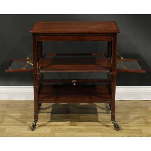 2694 - An Edwardian mahogany butler’s patisserie serving trolley, rectangular top above four glazed fall fr... 