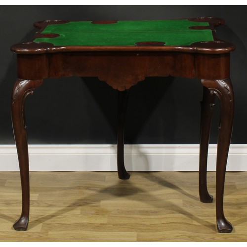 1730 - A George II Irish mahogany card table, hipped rectangular folding top enclosing a baize lined playin... 