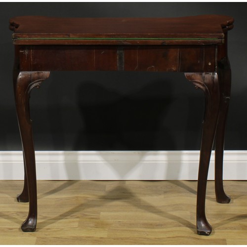 1730 - A George II Irish mahogany card table, hipped rectangular folding top enclosing a baize lined playin... 