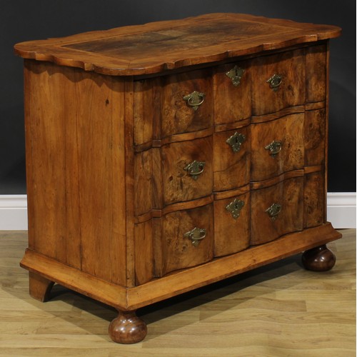 1990 - An 18th century design walnut arc-en-arbalète chest, oak featherbanded top above three long drawers,... 