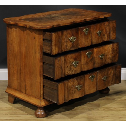 1990 - An 18th century design walnut arc-en-arbalète chest, oak featherbanded top above three long drawers,... 