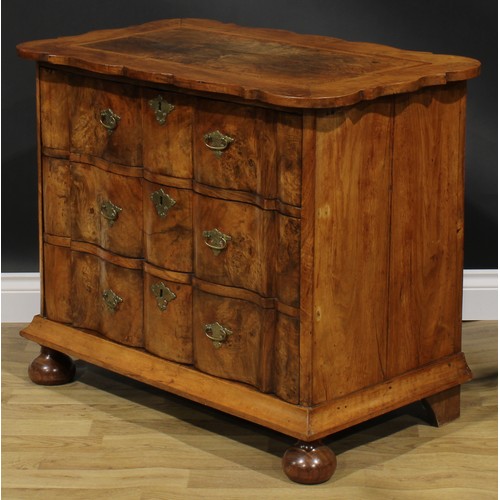 1990 - An 18th century design walnut arc-en-arbalète chest, oak featherbanded top above three long drawers,... 