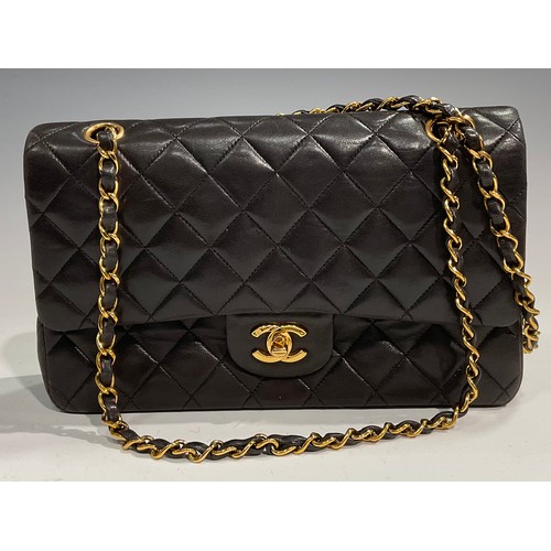 2075 - A Chanel quilted black lambskin leather handbag, double flap with burgundy leather interior, signatu... 