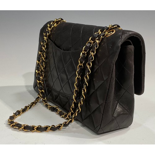 2075 - A Chanel quilted black lambskin leather handbag, double flap with burgundy leather interior, signatu... 