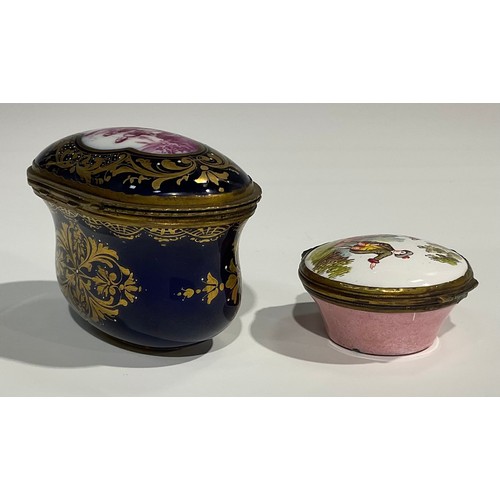 2236 - A French ovoid ceramic and gilt box, decorated with a scene of a lady and gentleman on a blue ground... 