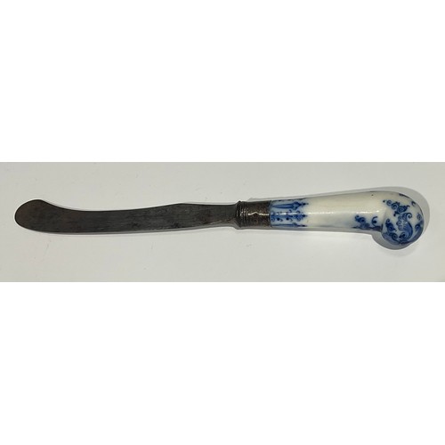 166 - A Bow porcelain knife handle, pistol grip, painted in underglaze blue with foliate tendrils and scro... 