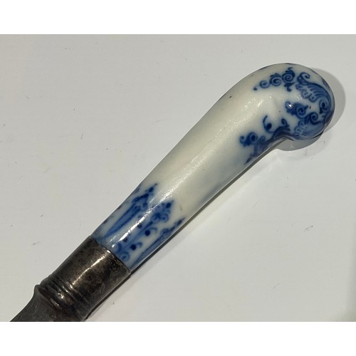 166 - A Bow porcelain knife handle, pistol grip, painted in underglaze blue with foliate tendrils and scro... 