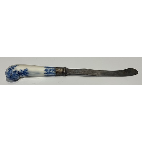 166 - A Bow porcelain knife handle, pistol grip, painted in underglaze blue with foliate tendrils and scro... 