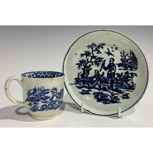 174 - A Liverpool coffee cup and saucer, painted in underglaze blue with a Chinoiserie landscape and figur... 