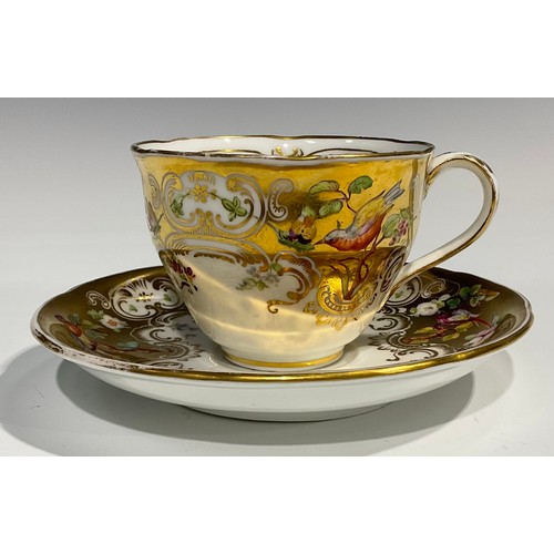 168 - A Coalport cup and saucer, painted with flowers and birds on a gilt ground, printed marks in green, ... 