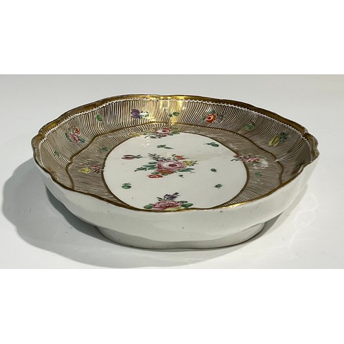 134 - A rare Bristol shaped oval cabaret tray, the central field painted with floral spray, with further f... 