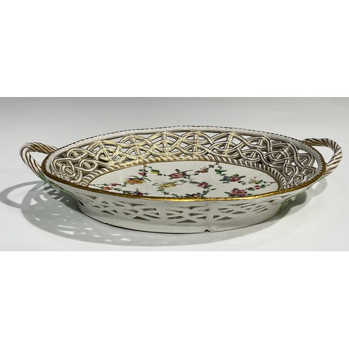 112 - A Bristol reticulated two handled basket, the field painted with a wreath of flowers and floral swag... 