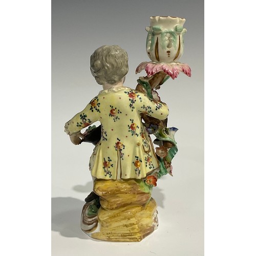 248 - A pair of Derby porcelain figural candlesticks, she seated with an apron of flowers, he holding his ... 