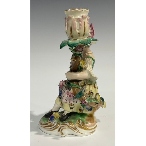 248 - A pair of Derby porcelain figural candlesticks, she seated with an apron of flowers, he holding his ... 