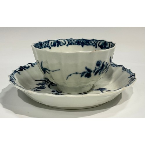 210 - A Worcester fluted Hollow Rock Lily pattern tea bowl and saucer, decorated in underglaze blue with r... 