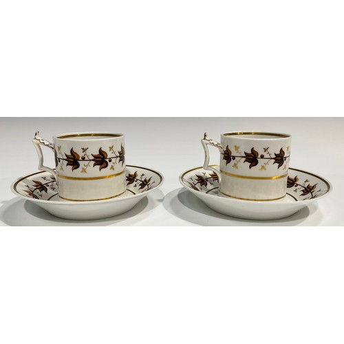 182 - A pair of Flight Barr coffee cans and saucers, painted with a band of stylised brown leaves, banded ... 