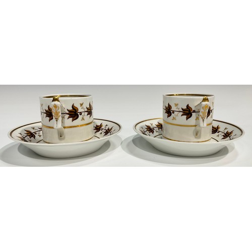 182 - A pair of Flight Barr coffee cans and saucers, painted with a band of stylised brown leaves, banded ... 