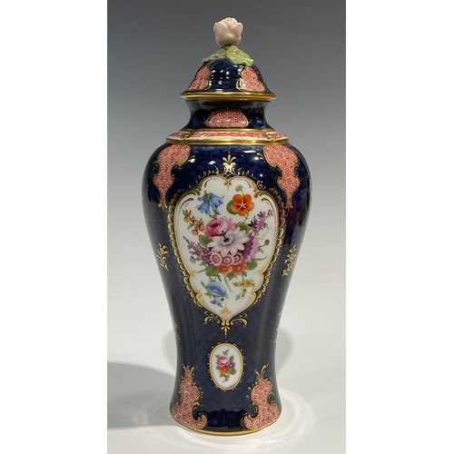 189 - A Royal Worcester baluster vase and cover, by Ernest Phillips, painted with panels of flowers on a b... 