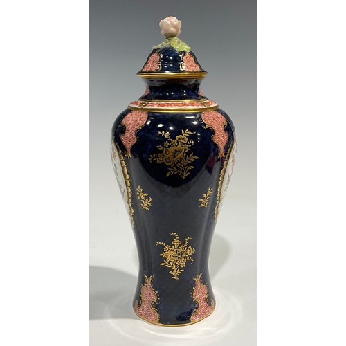 189 - A Royal Worcester baluster vase and cover, by Ernest Phillips, painted with panels of flowers on a b... 