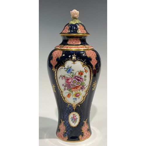 189 - A Royal Worcester baluster vase and cover, by Ernest Phillips, painted with panels of flowers on a b... 