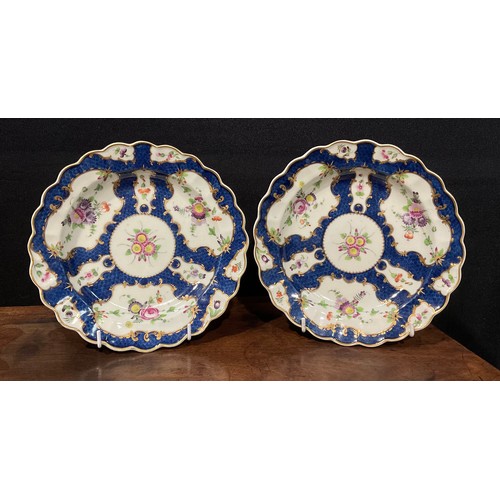 185 - A pair of Worcester shaped circular plates, decorated with alternating fan and vase shaped reserves,... 