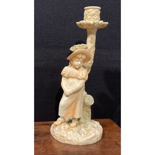 195 - A Royal Worcester figural candlestick, in the manner of Hadley, of a girl leaning against a tree, in... 