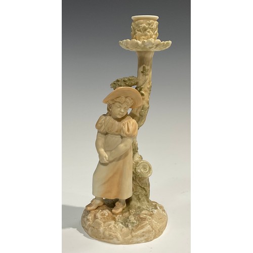 195 - A Royal Worcester figural candlestick, in the manner of Hadley, of a girl leaning against a tree, in... 