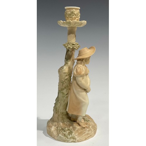 195 - A Royal Worcester figural candlestick, in the manner of Hadley, of a girl leaning against a tree, in... 