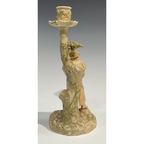 195 - A Royal Worcester figural candlestick, in the manner of Hadley, of a girl leaning against a tree, in... 