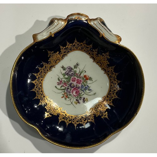 222 - A Worcester shell shaped dish, the field painted with a bouquet of summer flowers within gilt border... 