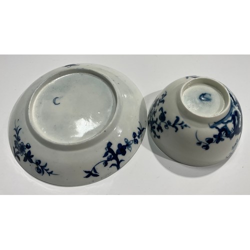 218 - A Worcester Prunus Roots pattern tea bowl and saucer, painted in underglaze blue with scrolling root... 