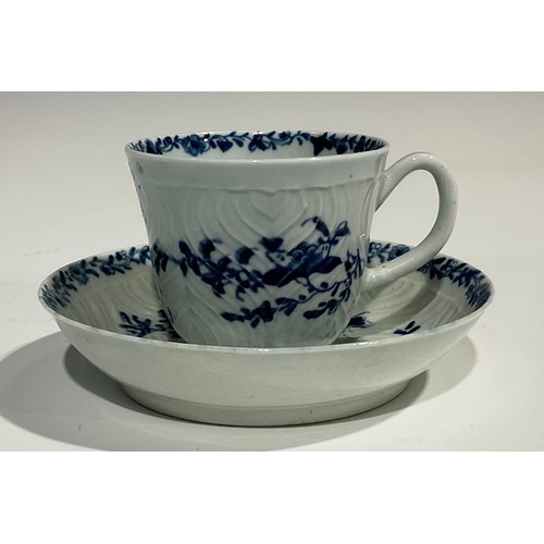 207 - A Worcester feather moulded coffee cup and saucer, painted in underglaze blue with garlands of flowe... 