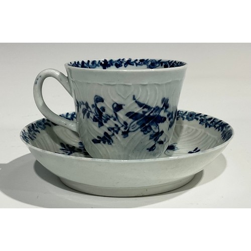 207 - A Worcester feather moulded coffee cup and saucer, painted in underglaze blue with garlands of flowe... 