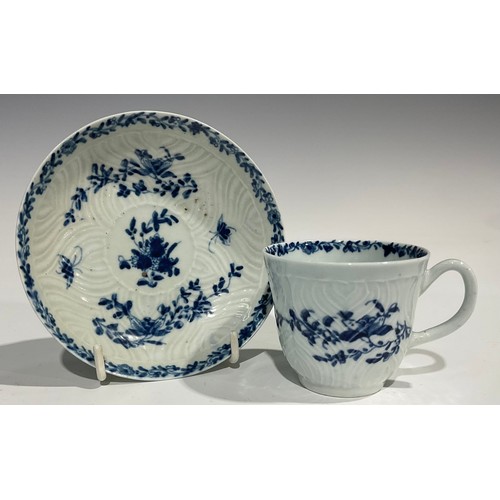 207 - A Worcester feather moulded coffee cup and saucer, painted in underglaze blue with garlands of flowe... 