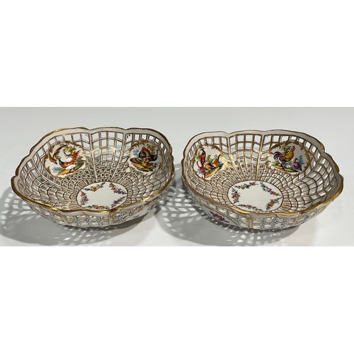 299 - A pair of Berlin reticulated baskets, each with four cartouches containing fanciful birds, the centr... 