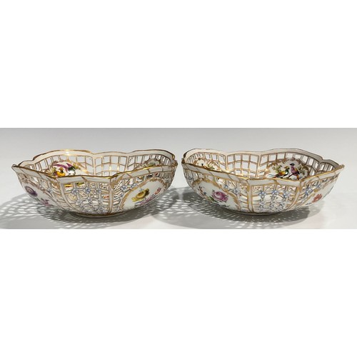 299 - A pair of Berlin reticulated baskets, each with four cartouches containing fanciful birds, the centr... 