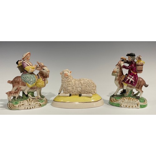 331 - A pair of early 19th century Staffordshire figures, The Welsh Tailor and Wife, both seated astride a... 