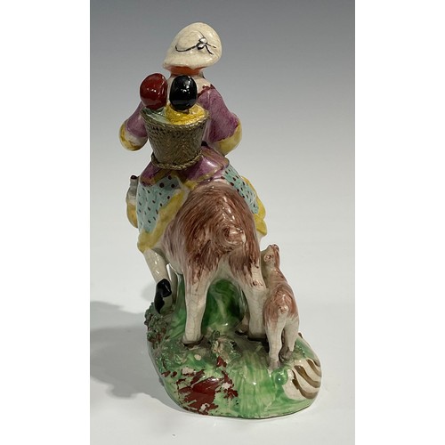 331 - A pair of early 19th century Staffordshire figures, The Welsh Tailor and Wife, both seated astride a... 