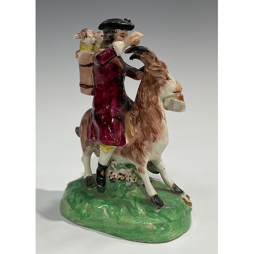 331 - A pair of early 19th century Staffordshire figures, The Welsh Tailor and Wife, both seated astride a... 