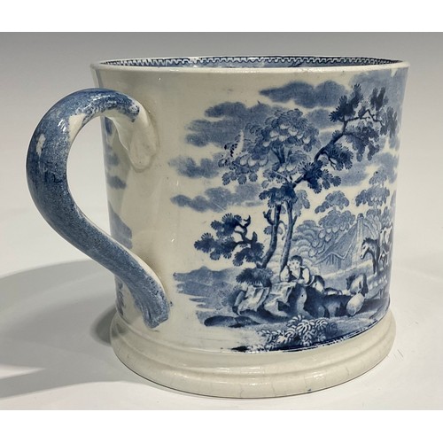 328 - A 19th century Staffordshire blue and white two handled loving cup, decorated with rural scene of ca... 