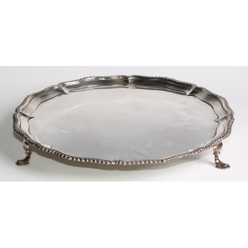 1101 - A Victorian silver salver, of George II design, gadrooned border, pad feet, 33cm wide, Hawksworth, E... 