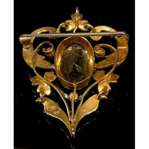 1510 - An Edwardian citrine and seed pearl brooch, stamped '9ct', the central large oval citrine 16mm high,... 