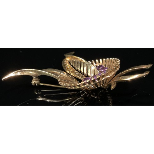 1337 - A 9ct gold stylised amethyst set leaf spray brooch, 8cm high, 11.8g